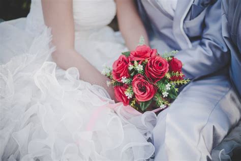 Bride Holds A Wedding Red Rose Bouquet In Hands The Groom Hugs Stock Image Image Of Beauty