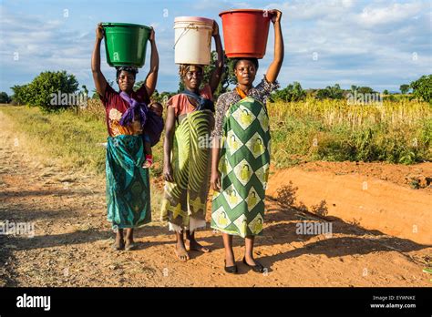 Local Women Carrying Buckets On Their Heads Malawi Africa Stock Photo