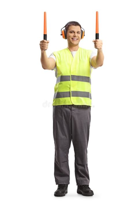 Aircraft Marshaller Signaling With Wands At An Airport Apron Stock