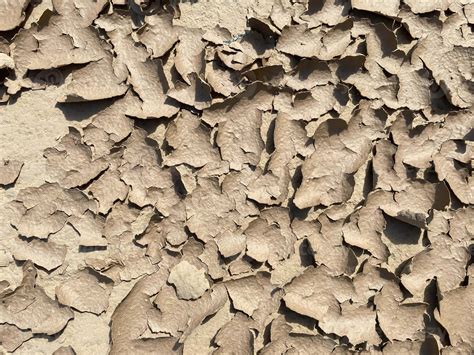 Texture Of Brown Dry Cracked Flaky Dirt And Ground With Sand