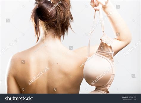 Стоковая фотография 183151577 Naked Woman Back View Holding Bra