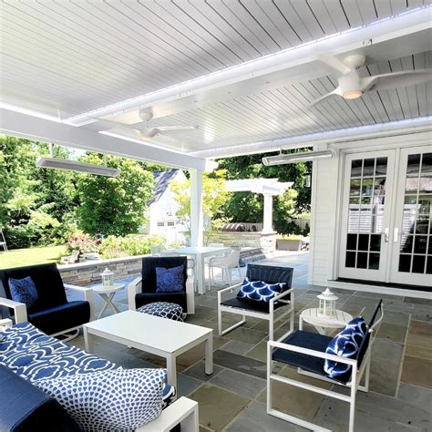 Outdoor Lounging Area Under Motorized Louvered Pergola Apollo Opening