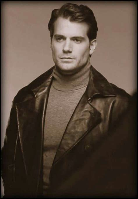 A Black And White Photo Of A Man In A Leather Jacket