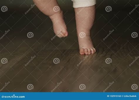 Legs Of Newborn Baby Close Up On Wooden Background Stock Image Image