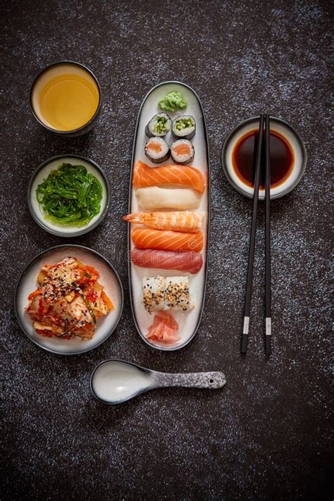 Asian Food Assortment Various Sushi Rolls Placed On Ceramic Plates