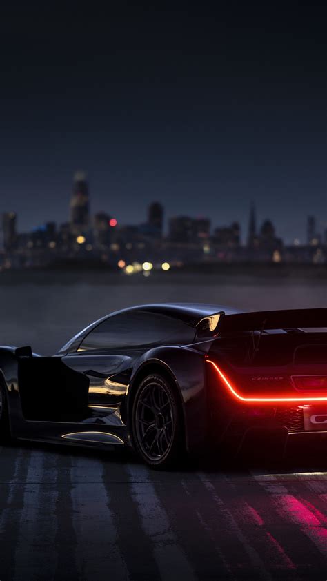 Sleek Sports Car Against Dusk Skyline Backiee