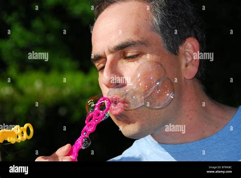 Man Blowing Soap Bubbles Stock Photo Alamy