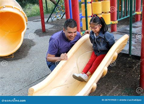 Dad With His Brunette Latina Daughter Play In The Park In The Games They Spend Quality Time In