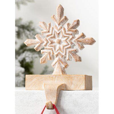 A Wooden Snowflake On Top Of A Piece Of Wood