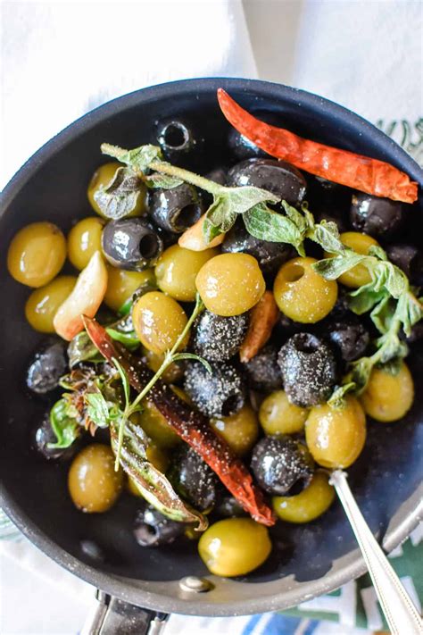 Olives And Carrots In A Frying Pan With Herbs