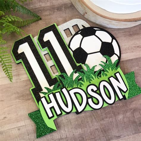 A Soccer Themed Birthday Cake Topper With The Number 11 And A Soccer