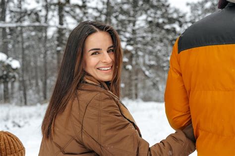 Premium Photo | Happy family having a walk in winter outdoors in snow ...