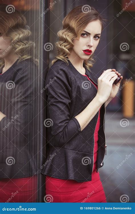 Beautiful Brunette Spy Agent Killer Or Police Woman In Leather Jacket And Red Luxury Dress With
