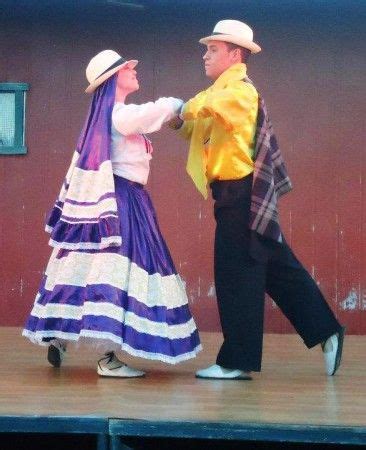 A Man And Woman Dancing On Stage During A Performance