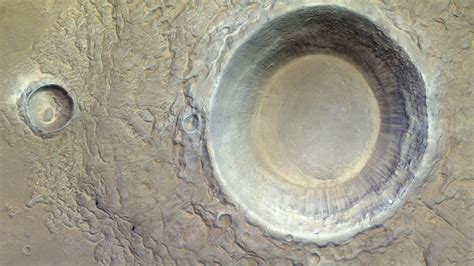 A massive, icy Mars crater stares up at a Red Planet orbiter (image ...