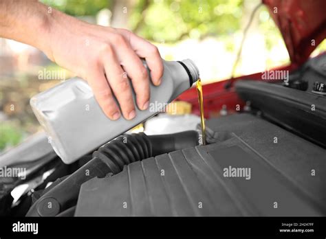 Mechanic Pouring Oil Into Car Engine Closeup Stock Photo Alamy