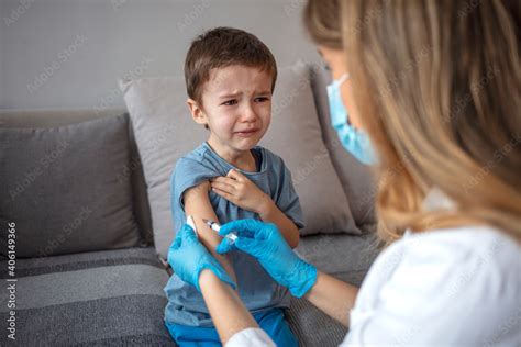 Boy Getting A Vaccine A Doctor Giving A Child An Injection At Home