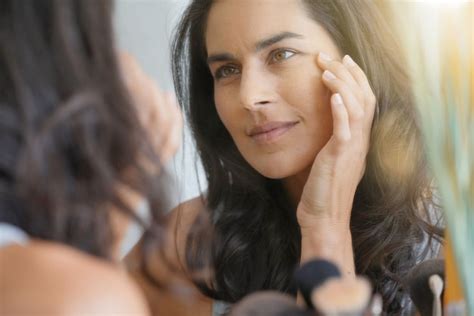 Premium Photo Beautiful Woman In Front Of Mirror Looking At Her Face