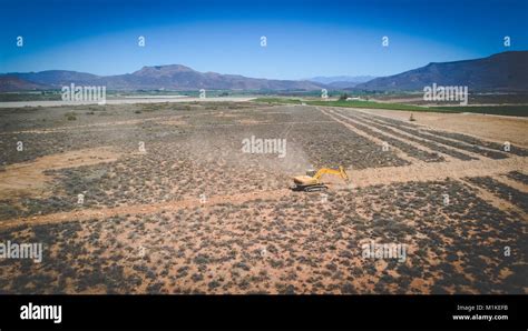 Aerial Photo Of Earth Moving Machinery Front Loader Digging A Trench On