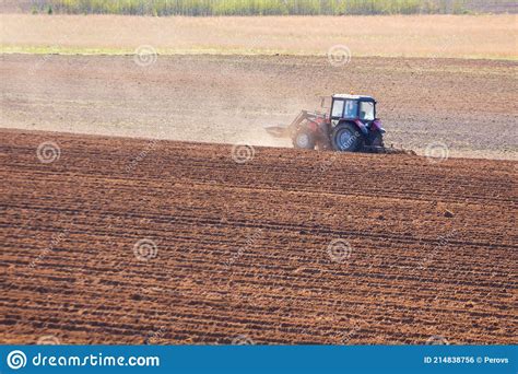 Tractor Plows The Field On A Sunny Spring Day Stock Photo Image Of