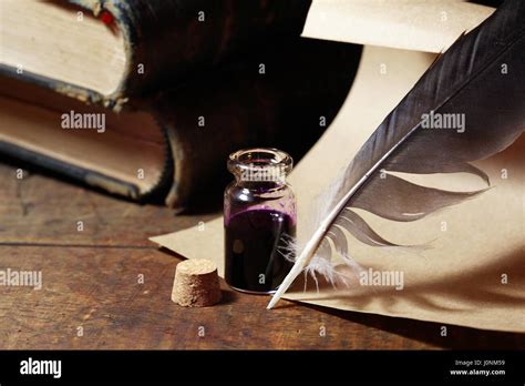 Vintage Still Life With Inkpot And Feather Near Scroll And Books Stock