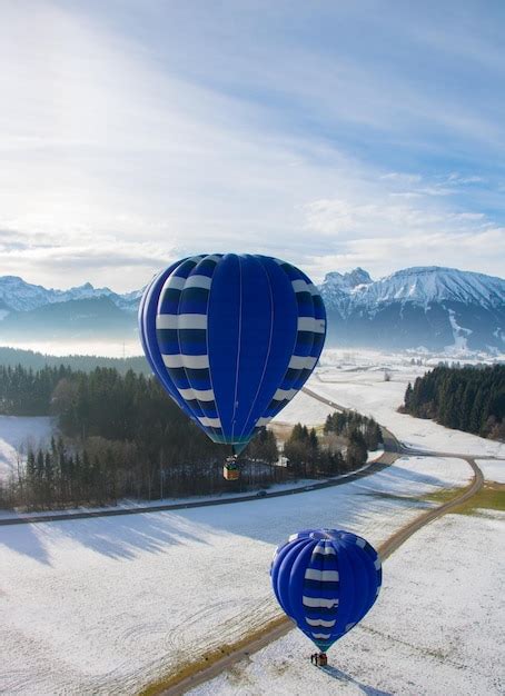 Premium Photo Hot Air Balloon Over Snow Covered Landscape