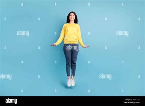 Full Size Photo Of Nice Optimistic Brunette Long Hairdo Lady Jump Wear Shirt Jeans Sneakers