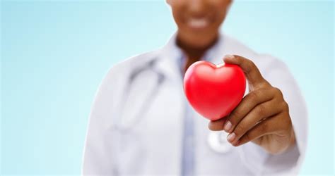 Premium Photo African American Doctor Hand Holding Red Heart