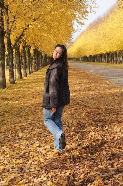 Premium Photo Happy Young Woman Walking Through Autumn Leaves