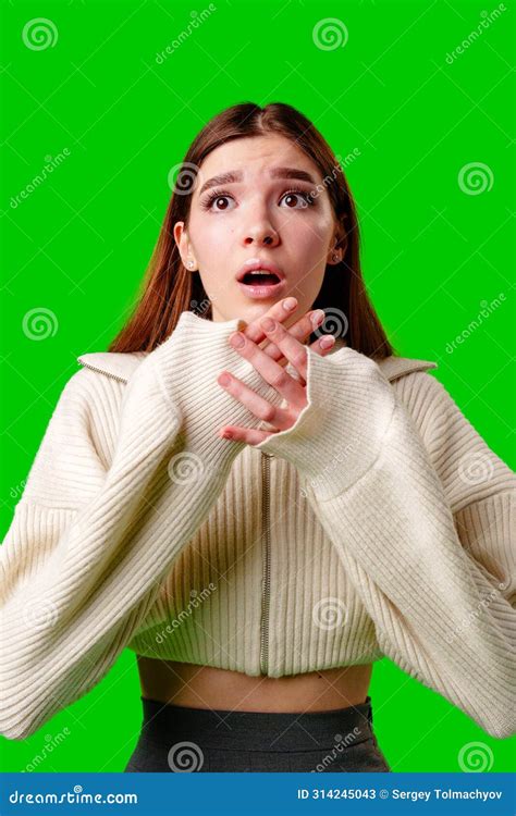 Young Woman Expressing Shock And Surprise Against A Green Screen