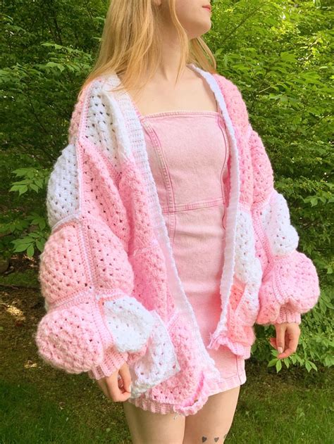 A Girl Stands Outside In A Pink And White Crochet Granny Square