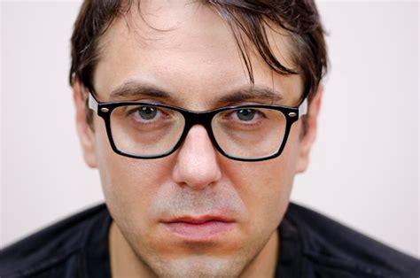 Premium Photo Close Up Portrait Of Man Wearing Eyeglasses Against