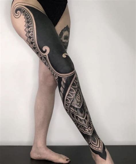 A Woman S Leg With Tattoos On It