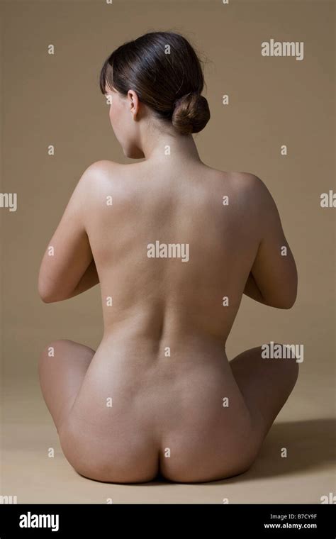 Rear View Of A Nude Woman Sitting Crossed Legged Stock Photo Alamy