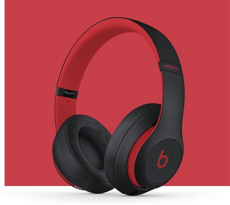 The Beats By Dr Dre Headphones Are Red And Black With One Earphone On