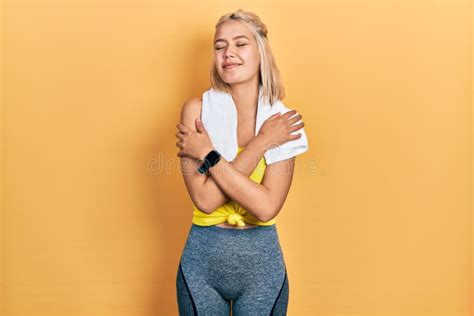 Beautiful Blonde Sports Woman Wearing Workout Outfit Hugging Oneself