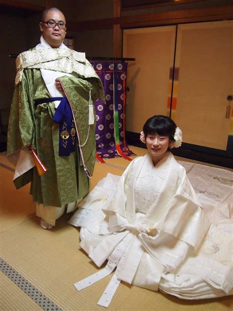 A Man Dressed As A Buddhist Monk Along With A Woman Dressed In An All