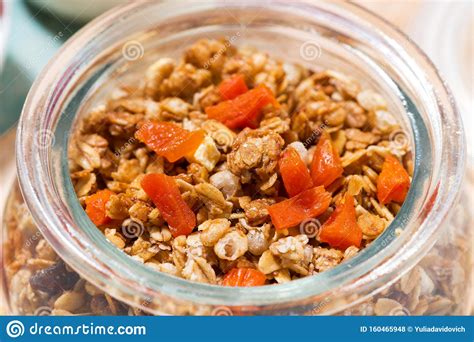 Homemade Granola With Dried Apricots And Nuts In A Jar Closeup Stock