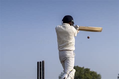 A Cricketer Playing Cricket On The Pitch In White Dress For Test