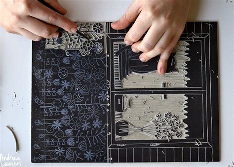 Two Hands Are Working On An Intricately Designed Piece Of Paper That Is