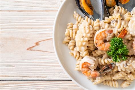 Premium Photo Spiral Pasta Mushroom Cream Sauce With Seafood