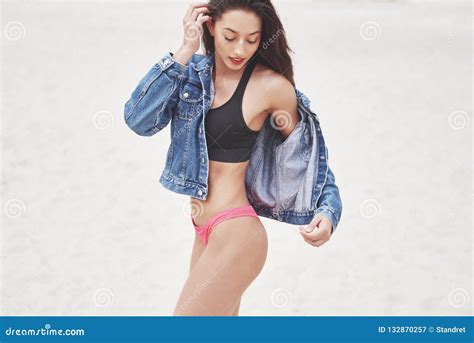 Beautiful Slim Luxury Girl In Bikini And Jeans Jaket On The Sand Beach On A Tropical Island