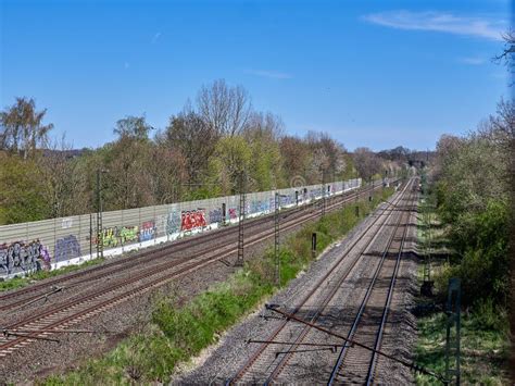 Train Track with a Graffiti Noise Barrier Stock Photo - Image of track ...