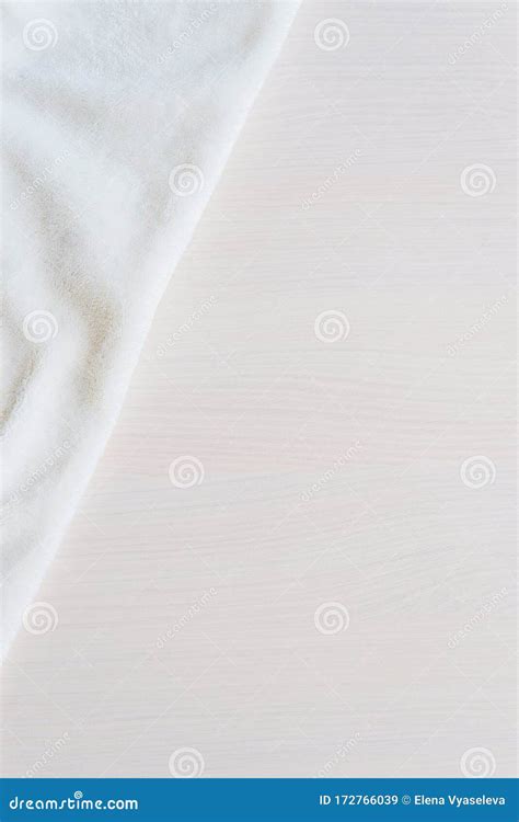 White Delicate Soft Background Of Plush Blancet Fabric On Biege White