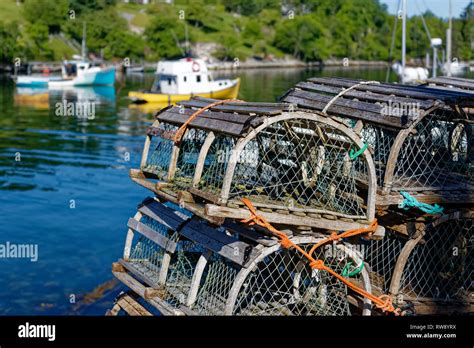 Stacks Of Traditional Wooden Lobster Traps On The Wharf In A Nova