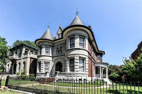 An Old Victorian Style House With Turrets On The Roof And Windows In