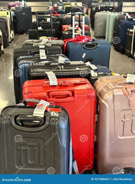An Airline Employee Scans Unclaimed Baggage In Richmond International