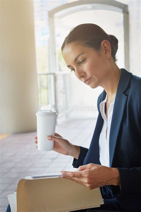 Catching Up With Work On Her Commute A Businesswoman Reading Paperwork