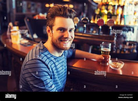 Happy Man Drinking Beer At Bar Or Pub Stock Photo Alamy