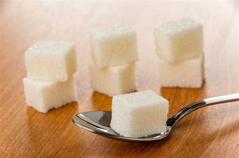 Few Sugar Cubes One Sugar Cube In Spoon On Wooden Table Stock Image